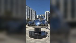 This set of streamlined landscape sculpture benches features undulating organic curved surfaces